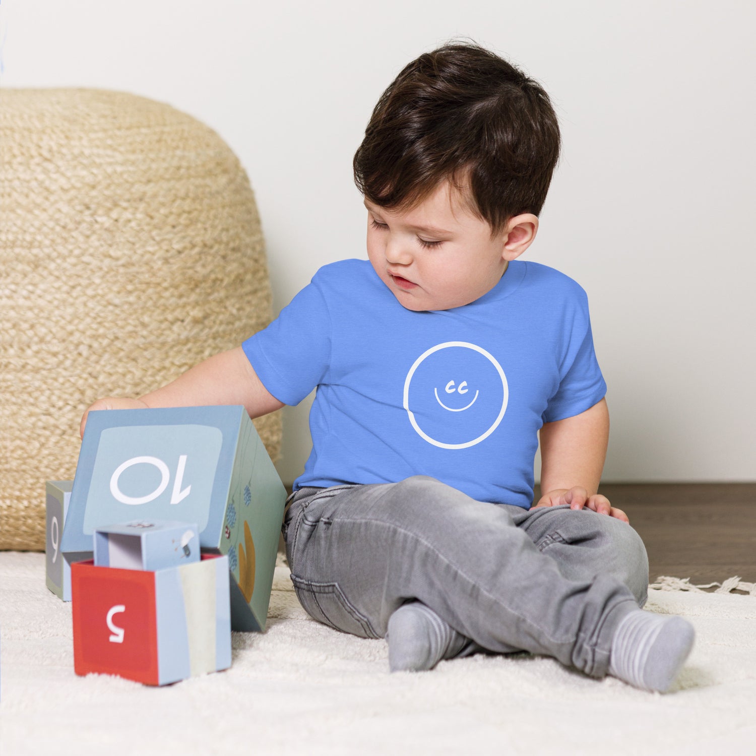 Baby wearing Big Smile T-Shirt playing with number blocks