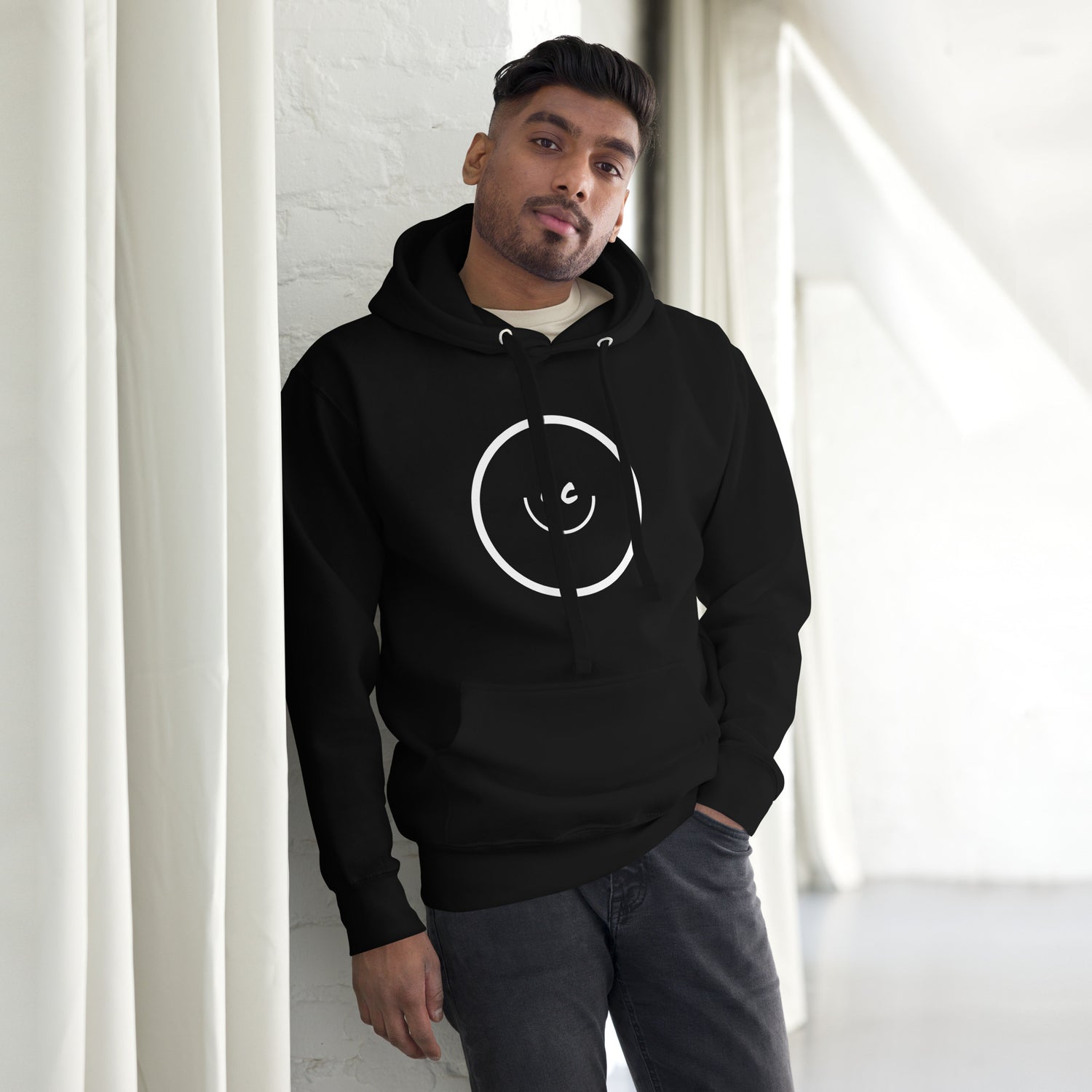 Man in Big Smile Hoodie leaning against pillar