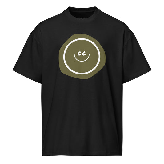 Grouchy Green oversized tee in black, featuring an earthy green imperfect shape behind the CC smile.