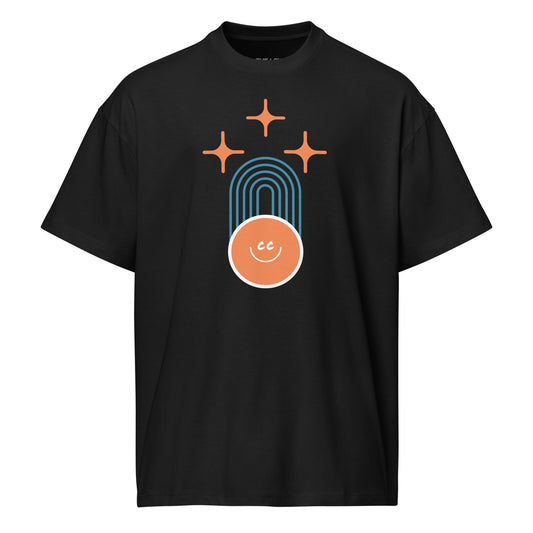 Shared Heritage tee in black, featuring geometric parallel lines, stars above, and the CC smile at the base.