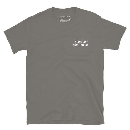 Charcoal t-shirt with 'Stand Out. Don't Fit In' in white text, minimalist design on chest.