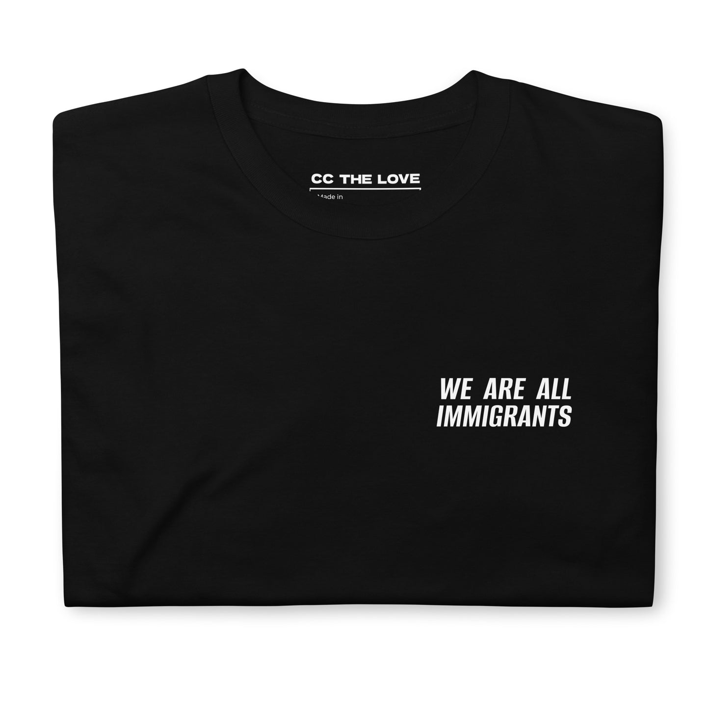 Black t-shirt with 'We Are All Immigrants' in white text, folded