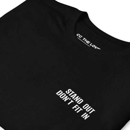 Black t-shirt with 'Stand Out. Don’t Fit In' in white bold font