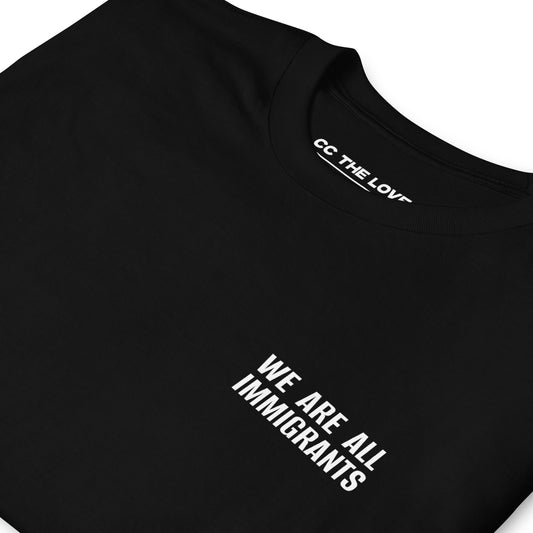 Black t-shirt with 'We Are All Immigrants' in white text
