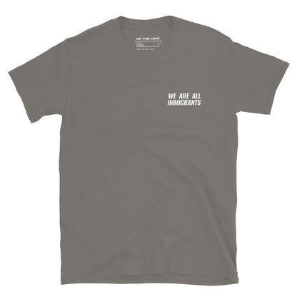 Charcoal t-shirt with 'We Are All Immigrants' in white text, minimalist design on chest. 