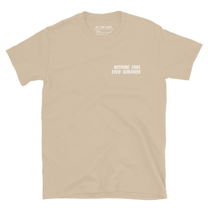 Sand t-shirt with 'Nothing Fake Ever Survives' in white text, minimalist design on chest.